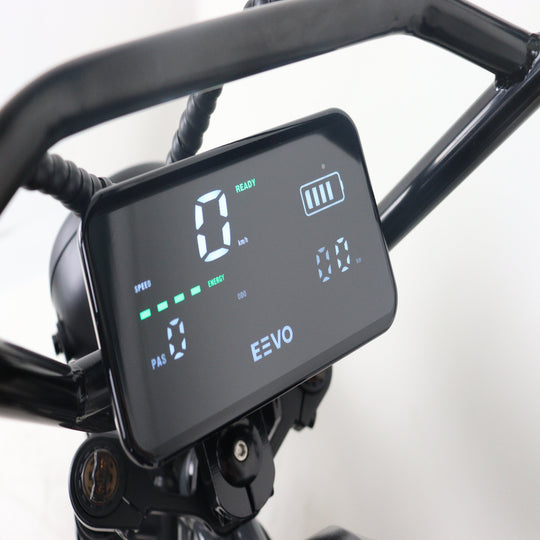 Digital display on a bike handlebar with 'EEVO' branding