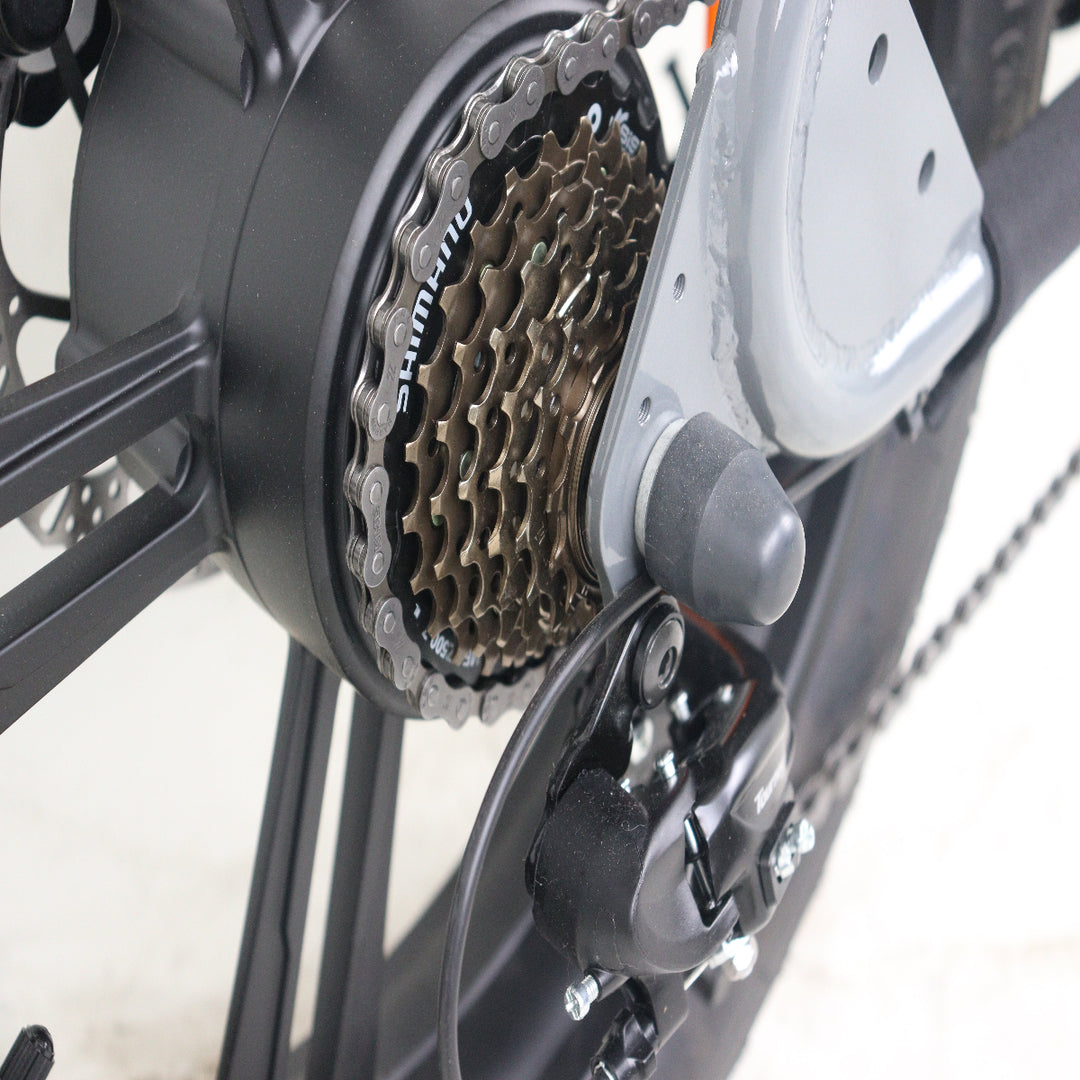 Close-up of a bicycle gear system with chain and sprocket on a white background