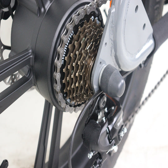Close-up of a bicycle gear system with chain and sprocket on a white background